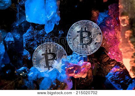 Silver bitcoin in a cave of precious stones. Bitcoin cryptocurrency.