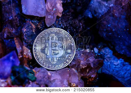 Silver bitcoin in a cave of precious stones. Bitcoin cryptocurrency.