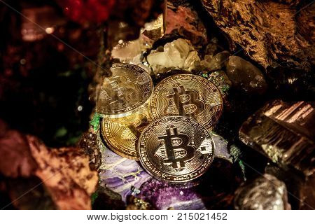 Silver and golden bitcoin in a cave of precious stones. Bitcoin cryptocurrency.