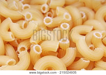 Fusilli dry pasta background concept. Pasta texture for background uses. Swirled pasta pattern. Food photography in studio. Texture background.