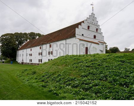 White exterior of Aalborghus Castle in the old town of Aalborg in Denmark