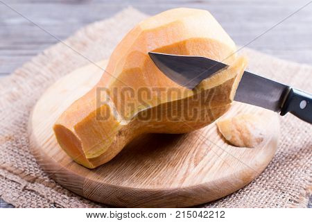 Fresh raw peeled pumpkin on wooden board