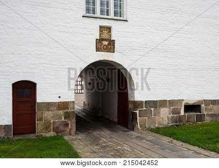 White exterior and entrance to Aalborghus Castle in the old town of Aalborg in Denmark