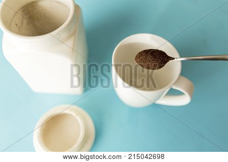 Coffee notebook plant and glases on a blue wooden table on a sunny day