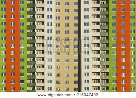 The facade of a typical block multi-storey residential building. Front view close up.