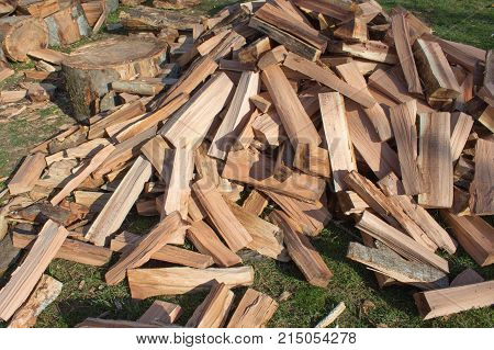 Firewood background - chopped firewood on a stack. Dry chopped firewood logs in a pile. pile of split firewood fuel material