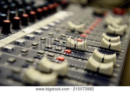 Detail view of buttons and slider on audio mix pult. Electronic device for playing music on cultural events and parties.