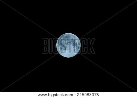 Full moon blue with craters on black sky