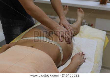 Brunette Fit Woman Client Receiving Body Massage At Spa Club By Tattooed Massagist. Top View