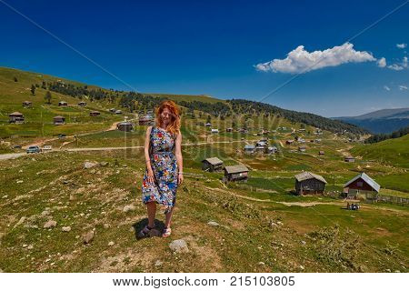 Young happy woman against mountain landscapes near Khulo village of Georgian Adjara region