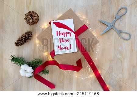 Homemade wrapped Christmas present with tools and decorations. Top view. Packing Christmas gifts