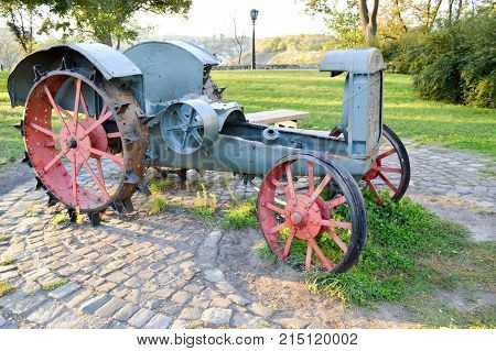 very old retro tractor with metal wheels