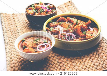 Aloo Gobi matar is a famous Indian curry dish with potatoes and cauliflower and green peas, selective focus