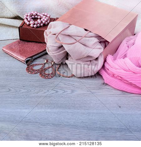 Accessories set for women wooden light background. Buying women gifts garments scarves jewelry haberdashery