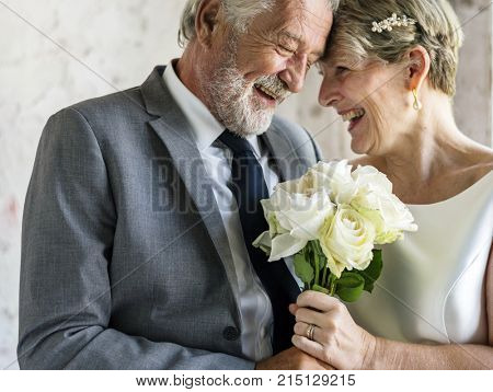 Senior Couple with White Roses Flower Bouqet