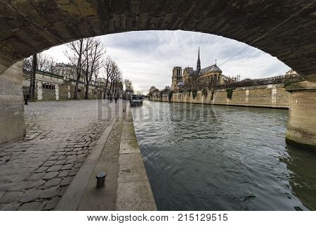 Cathedral Notre Dame De Paris Under The Pont Marie Bridge Along The Seine River