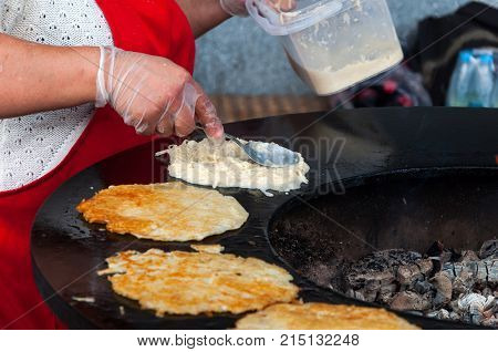 delicious draniki traditional Russian, Ukrainian and Belarusian dishescook on charcoal