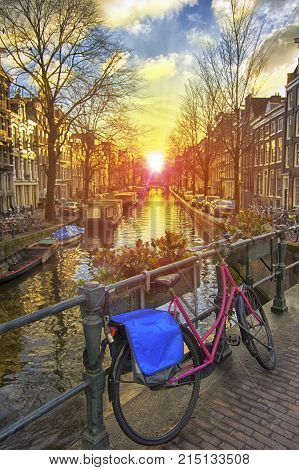 Beautiful spring sunrise view of Amsterdam canal along the bridge where Amsterdamers used to park their bicycle Netherlands