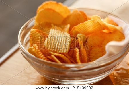 Potato Chips In Bowl On Wooden Table At Sunset