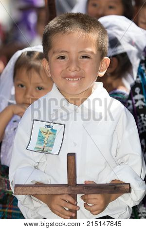 March 25, 2016 San Pedro la Laguna, Guatemala: a young mayan boy holding a wooden cross during Easter Holy week celebration
