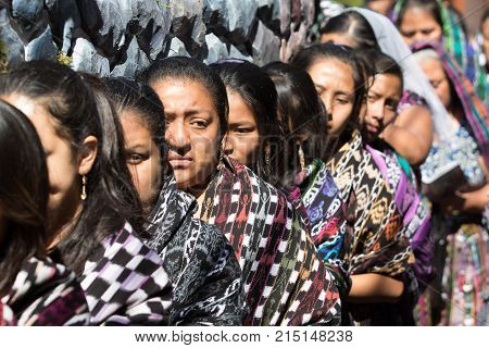 March 25, 2016 San Pedro la Laguna, Guatemala: women float carriers wearing traditional Mayan dress during Easter Week celebration