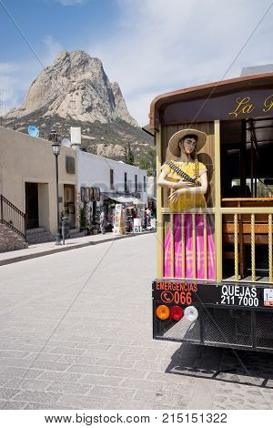 February 26, 2016 Bernal Mexico: tourist bus with the Bernal monolith in the background, the third largest monolith in the world