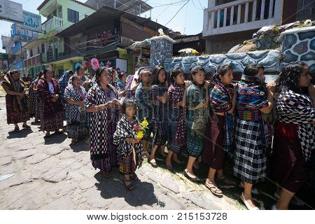 March 25, 2016 San Pedro la Laguna, Guatemala: women float carriers wearing traditional Mayan dress during Easter Week celebration