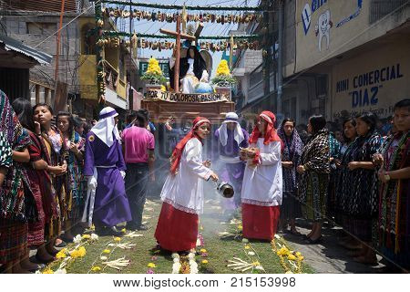 March 25, 2016 San Pedro la Laguna, Guatemala: a float with religious statues is being carried across the colorful ground covering during Easter procession