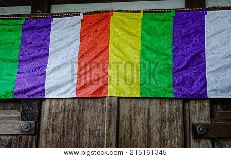 Buddhist Flag At A Wooden Temple