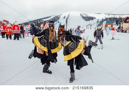 Sheregesh, Kemerovo region, Russia - April 22, 2017: Grelka Fest is a sports and entertainment activity for ski and snowboard riders in carnival costume. Two girls in a costumes of Batman.