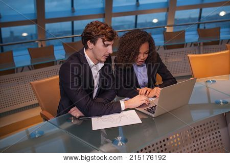 Business people having meeting around table in modern office.
