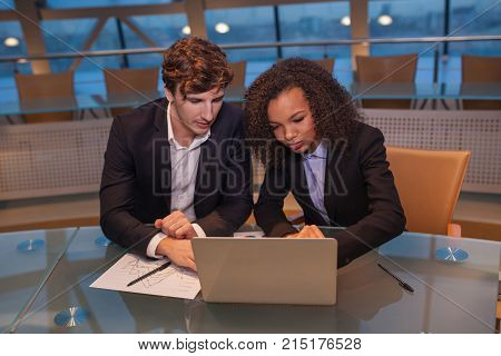 Business people having meeting around table in modern office.