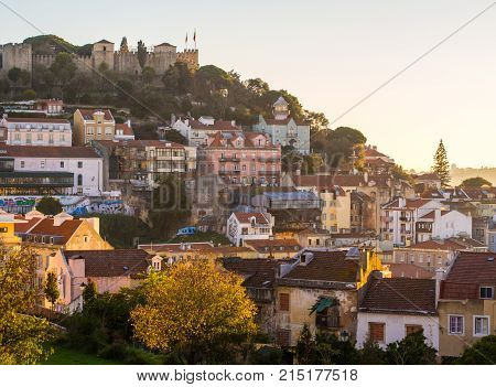 LISBON, PORTUGAL - NOVEMBER 19, 2017: Sao Jorge Castle in Lisbon Portugal with the sourrounding architecture at sunset.