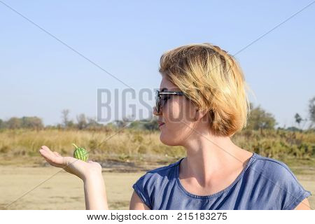 Girl With A Small Watermelon In Her Hand. The Embryo Of Watermelon.