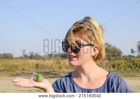 Girl With A Small Watermelon In Her Hand. The Embryo Of Watermelon.