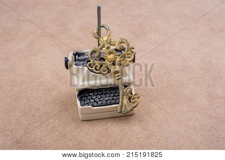 Retro Syled Tiny Typewriter Model On White Background