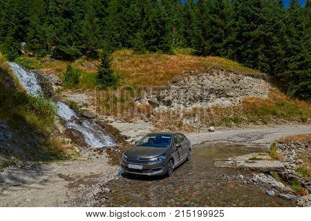 KHULO, GEORGIA - 08 AUGUST 2017: Car in water of the mountain waterfall near Khulo village of Georgian Adjara region
