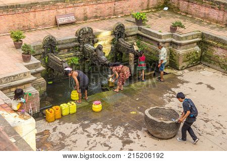 PATAN NEPAL - September 23 2013: Historic place of water extraction in Patan town. Patan ancient city in Kathmandu Valley. Lalitpur Metropolitan City is the third largest city of Nepal.