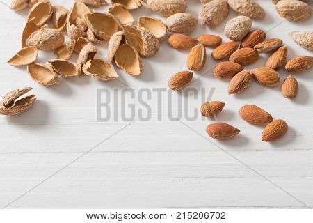 salted almonds in shell on wooden background