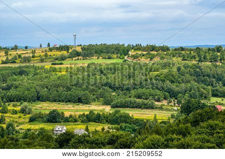 Summer rural landscape. Homes in the countryside among the green hills.