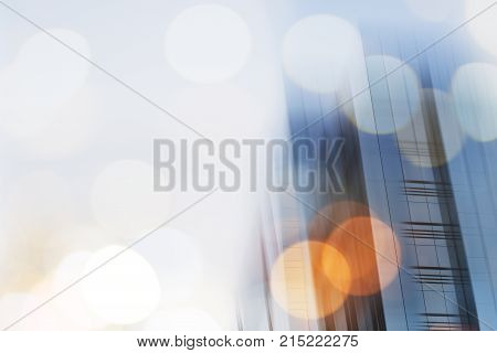 Abstract business modern city urban futuristic architecture background. Real estate concept, motion blur, reflection in glass of high rise skyscraper facade, toned blue picture with bokeh.