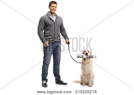 Full length portrait of a young man with a labrador retriever holding a newspaper isolated on white background