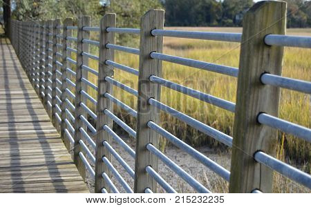 boardwalk bridge with wooden deck and metal rails
