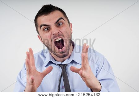 Angry business man expressing frustration portrait of young handsome businessman concept of executive yelling conversation problem communication crisisangerfrustration.Room for text