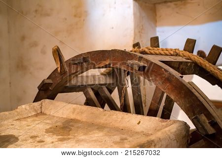 Close up wooden wheel part of watre supply system in historical Amer Fort in India