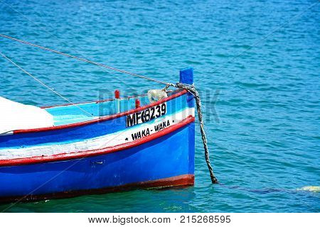 MARSAXLOKK, MALTA - APRIL 1, 2017 - Traditional Maltese Dghajsa fishing boat in the harbour Marsaxlokk Malta Europe, April 1, 2017.