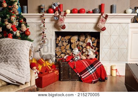 Cozyness And Home Comfort. Decorated Fireplace With Firewood. Winter Holidays Room Interior, Christm