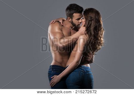 Kissing sexy couple in embrace in studio