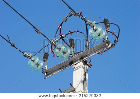 High voltage tower electric post and wires on blue sky background