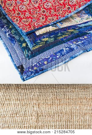 decoration, color design, texture, garment manufacturing, sewing concept - there is combination of bright red and calm blue colores in folksy blanket made of satin rags in traditional style